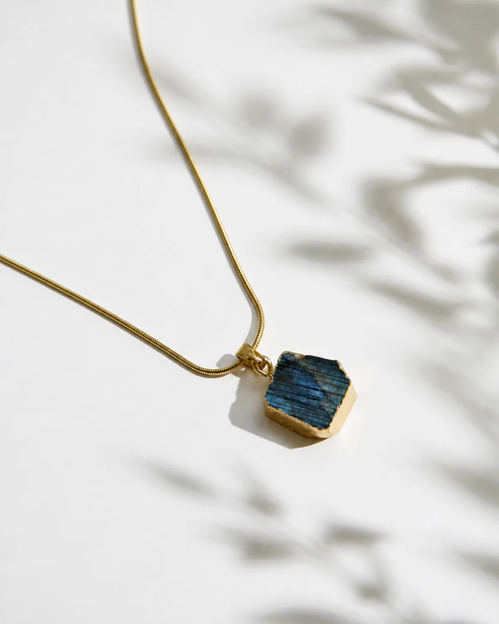 Raw labradorite gold pendant necklace close-up