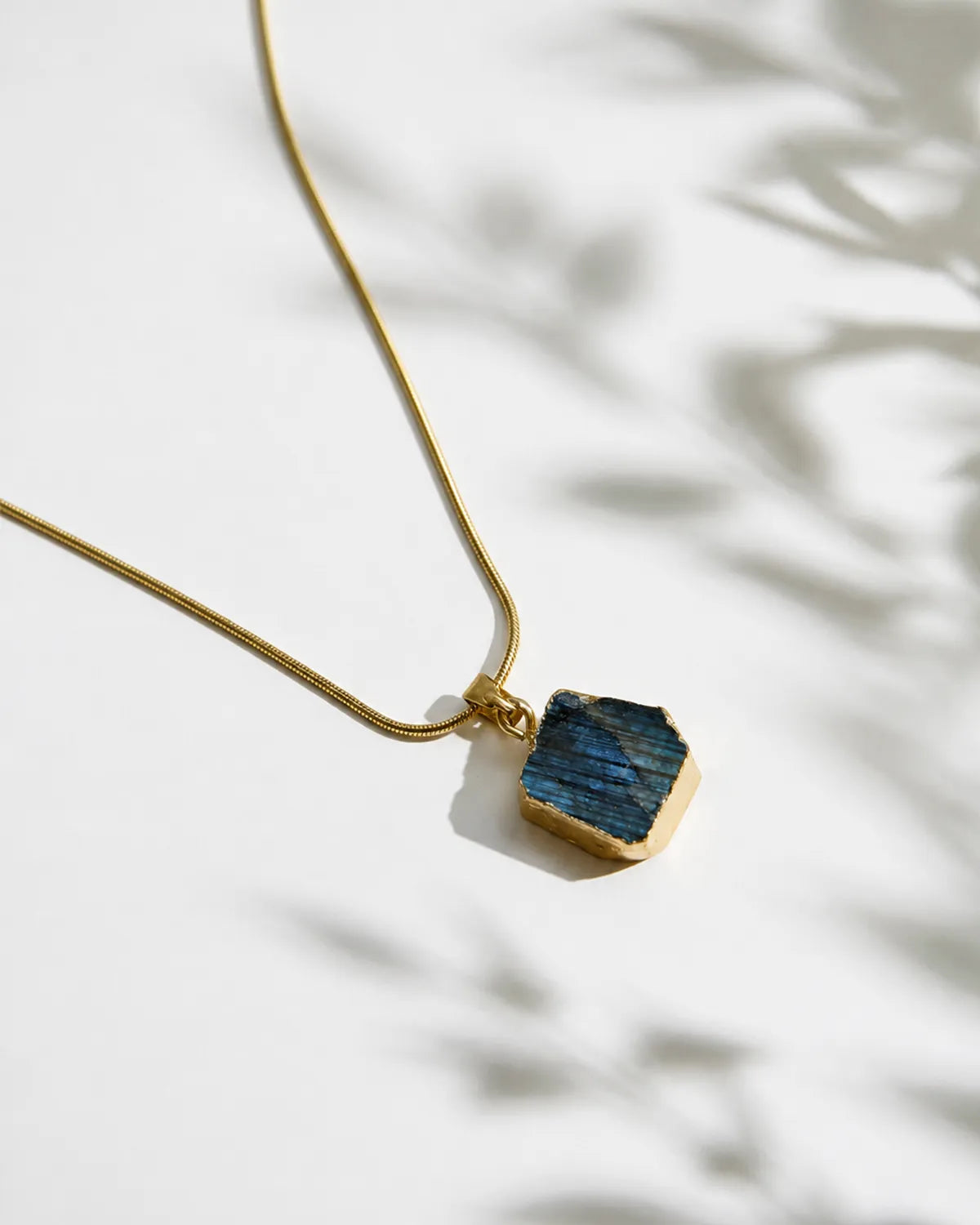 Raw labradorite gold pendant necklace close-up