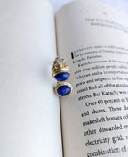 Gold blue open ring on book