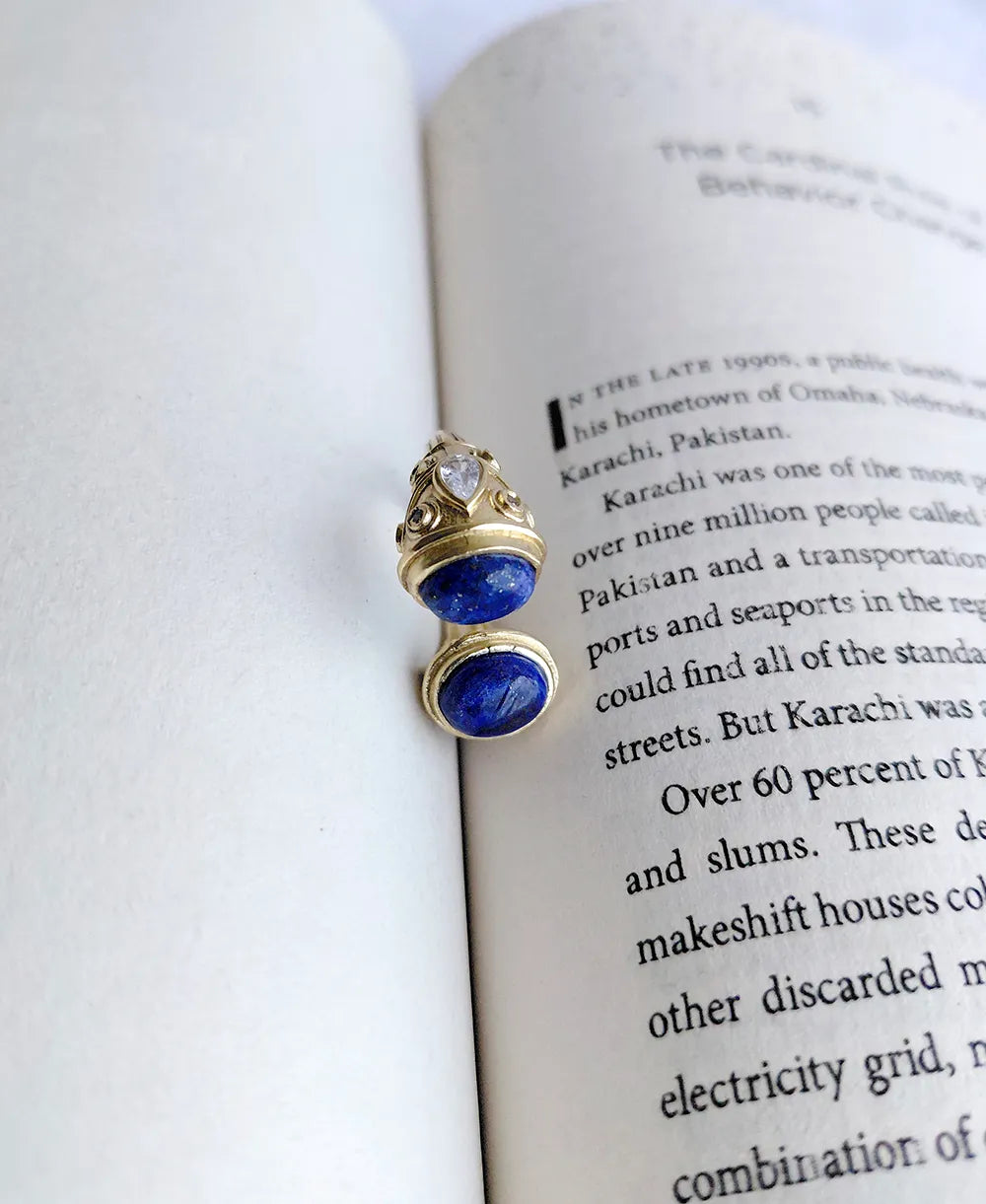 Gold blue open ring on book