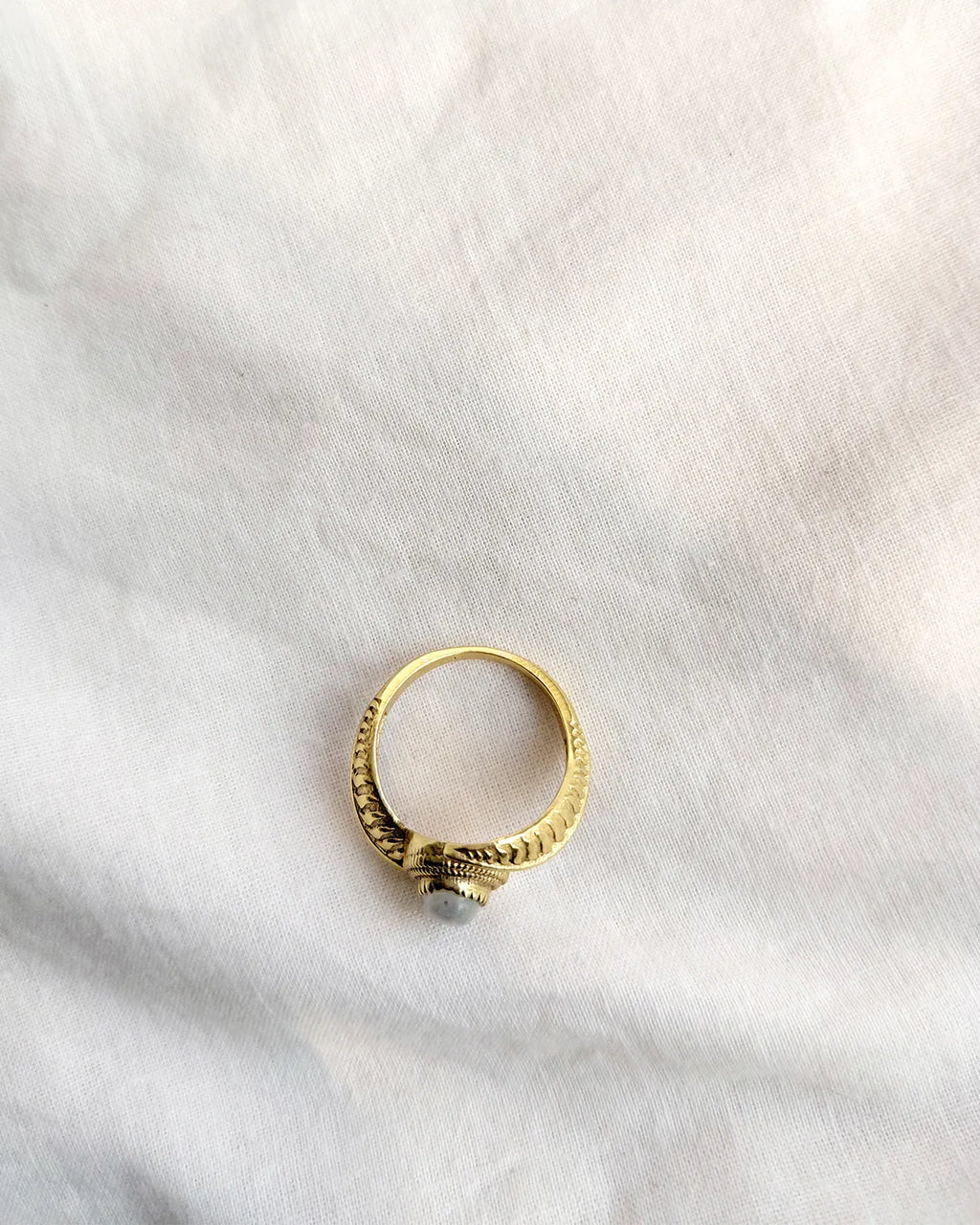 Top view gold-tone vintage ring with grey oval stone