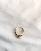 Top view gold-tone vintage ring with grey oval stone