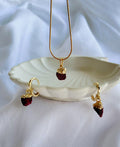 Crimson Muse Garnet Jewellery Set with raw garnet pendant necklace, matching hoop drop earrings and 18K gold-plated snake chain.