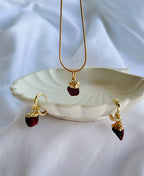 Crimson Muse Garnet Jewellery Set with raw garnet pendant necklace, matching hoop drop earrings and 18K gold-plated snake chain.