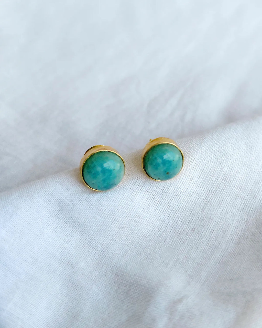 Turquoise blue round gold stud earrings by Solmist Muse – view 1