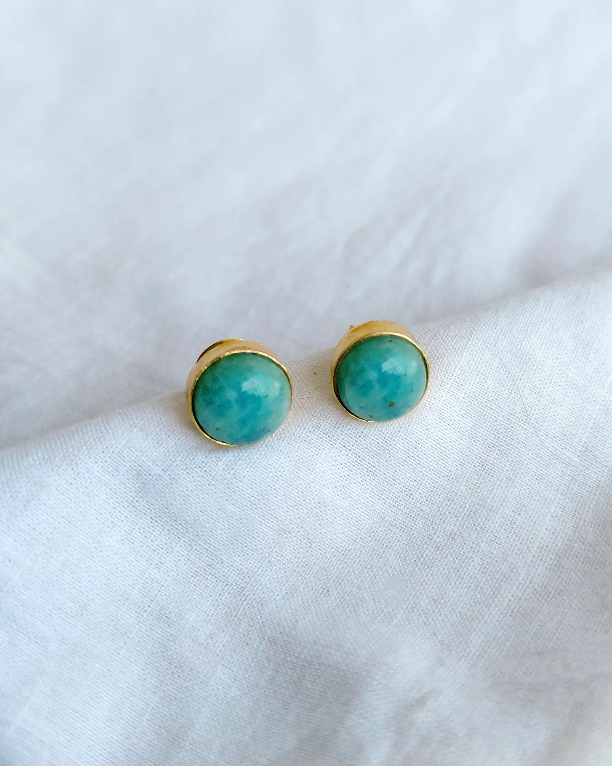 Turquoise blue round gold stud earrings by Solmist Muse – view 1