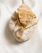 Raw rose quartz gold pendant necklace close-up