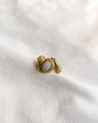 Front view gold-tone leaf vintage ring with oval grey stone