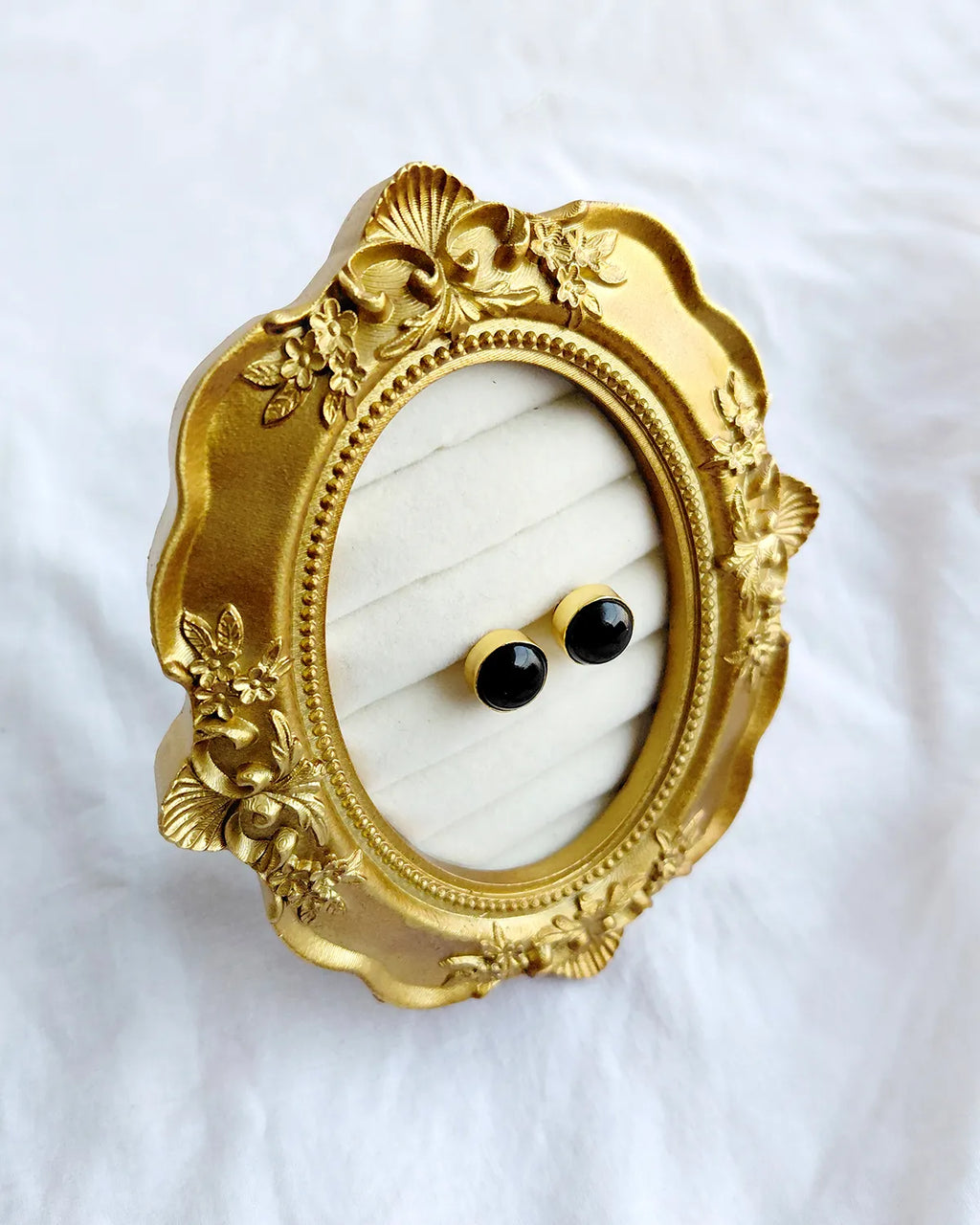Classic round black stud earrings in gold-tone setting