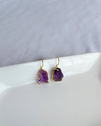 Raw purple amethyst earrings with gold-tone hook settings