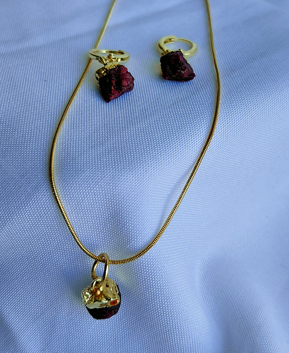 Crimson Muse Garnet Jewellery Set with raw garnet pendant necklace, matching hoop drop earrings and 18K gold-plated snake chain.
