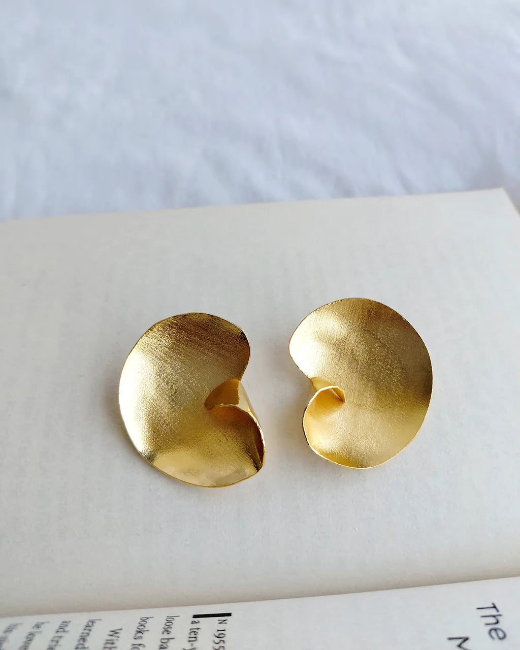 Sculptural gold swirl statement earrings