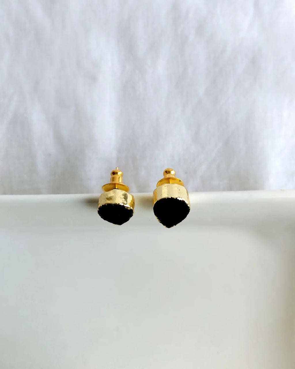 Black teardrop gold plated stud earrings view 1