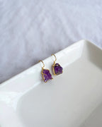 Raw purple amethyst earrings with gold-tone hook settings