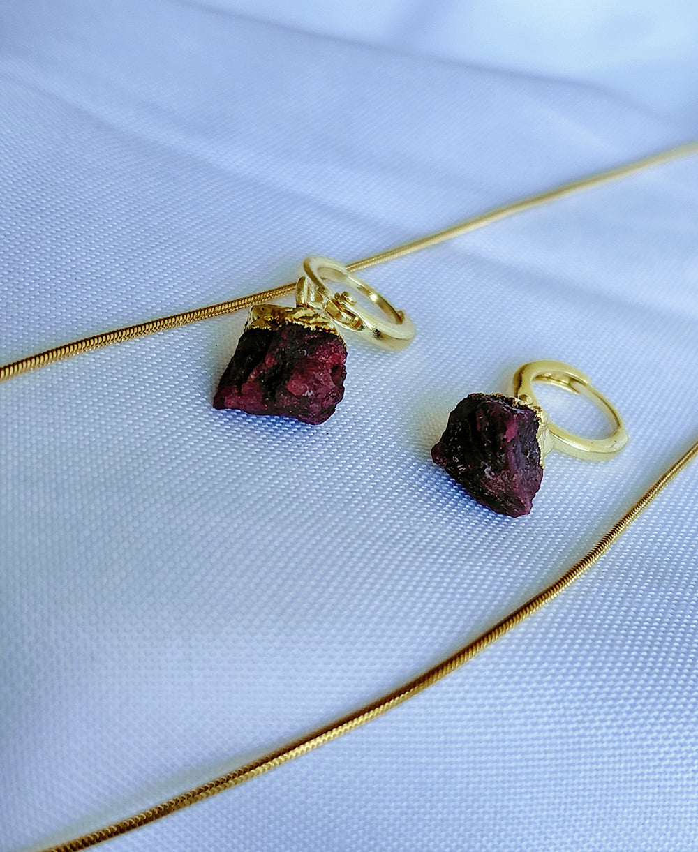 Crimson Muse Garnet Jewellery Set with raw garnet pendant necklace, matching hoop drop earrings and 18K gold-plated snake chain.