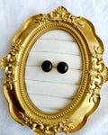 Classic round black stud earrings in gold-tone setting