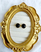 Classic round black stud earrings in gold-tone setting