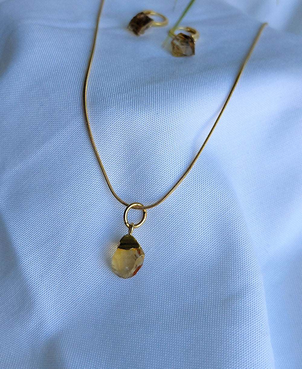 Solara Gemstone Jewellery Set with raw citrine pendant necklace, matching hoop drop earrings and 18K gold-plated snake chain.