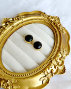 Classic round black stud earrings in gold-tone setting