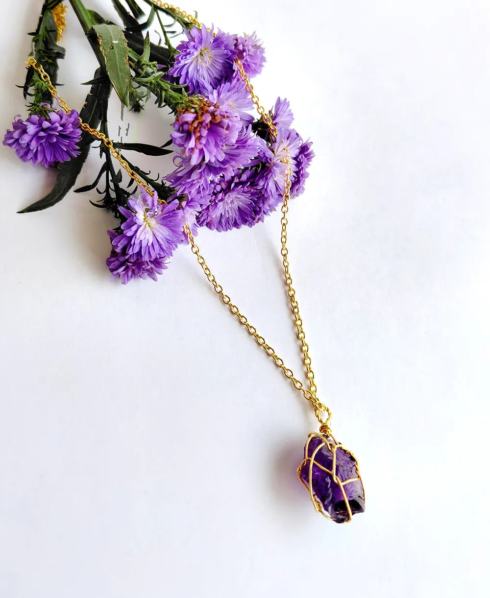 Gilded Violet Crystal Necklace with natural raw amethyst crystal and 18K gold-plated wire-wrapped pendant.