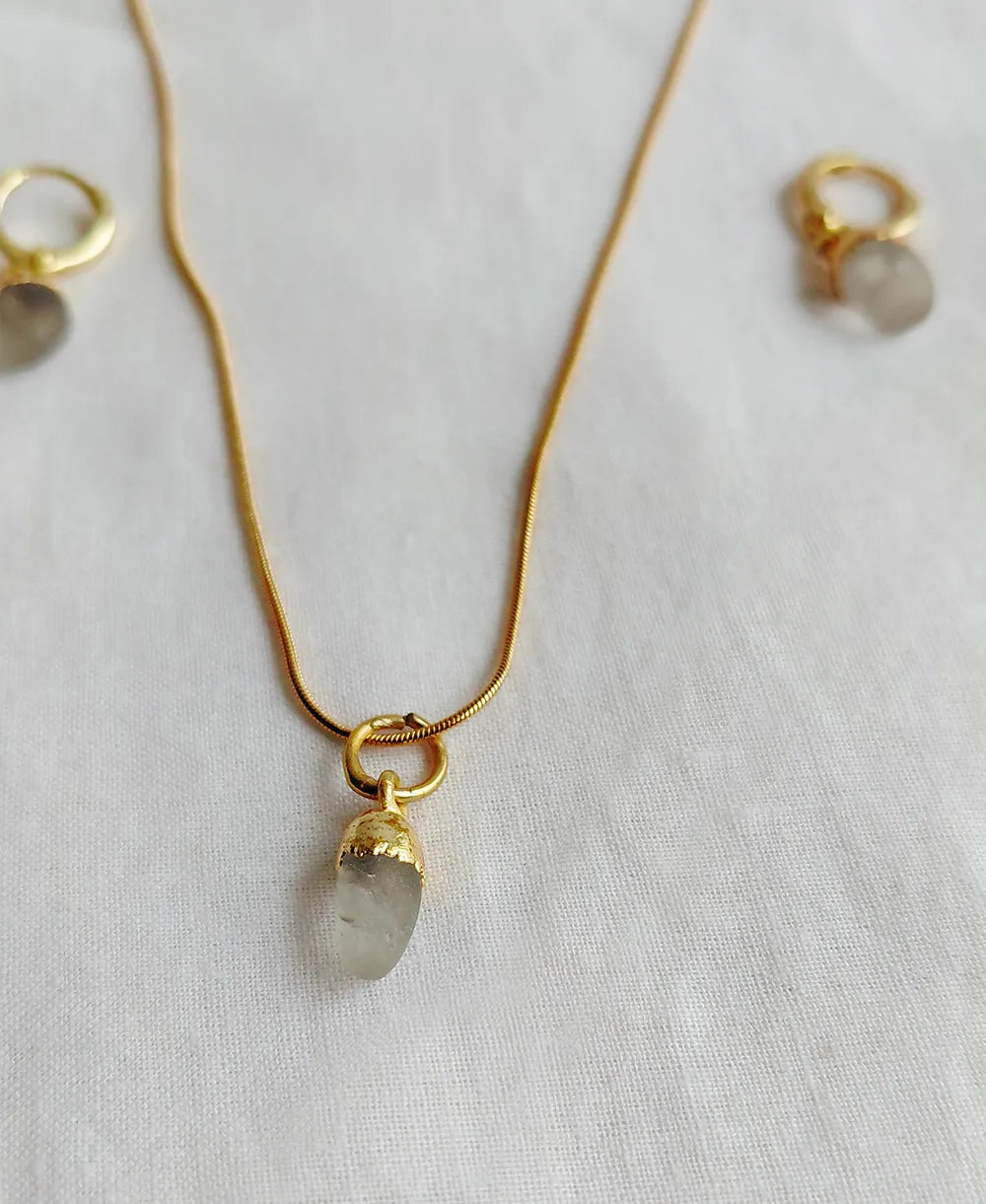 Clear Quartz pendant necklace with coordinating gemstone hoop earrings.