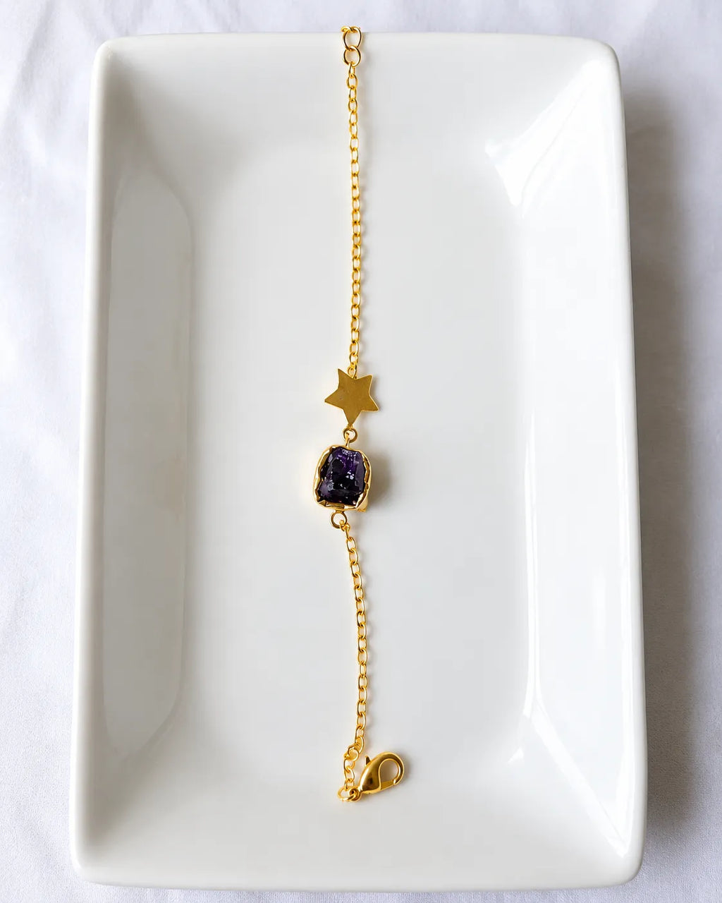 Amethyst star bracelet on white jewelry tray