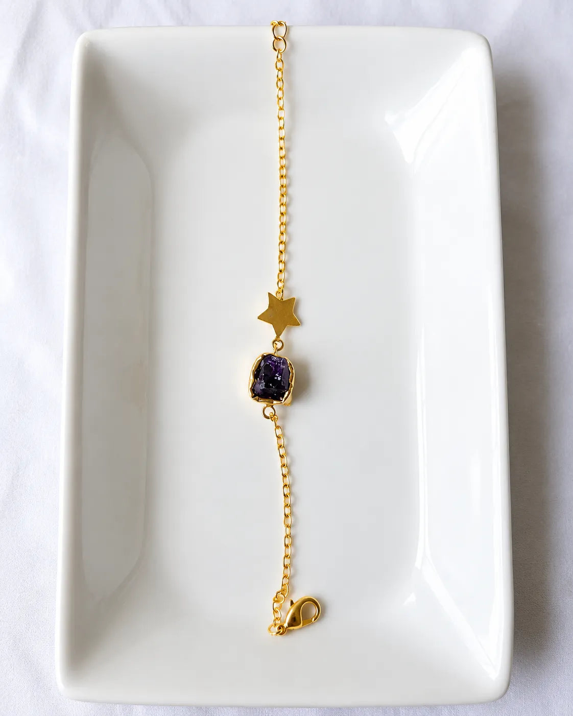 Amethyst star bracelet on white jewelry tray