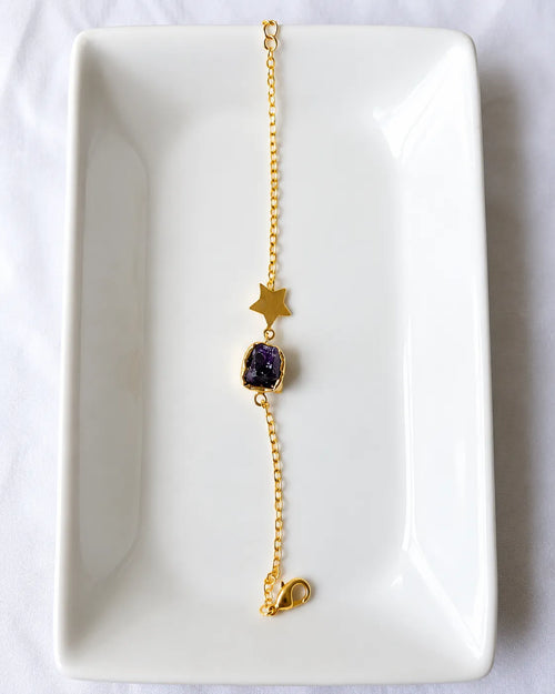 Amethyst star bracelet on white jewelry tray