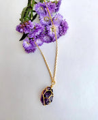 Gilded Violet Crystal Necklace with natural raw amethyst crystal and 18K gold-plated wire-wrapped pendant.