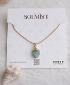 Sea Glass Aquamarine 18K Gold Plated Necklace with natural raw blue gemstone and gold-capped pendant on snake chain.