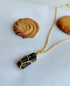 Noir Shield Black Tourmaline Pendant with natural raw black tourmaline crystal and 18K gold-plated wire-wrapped design.