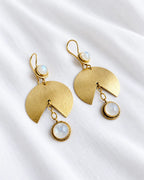 Moonstone gold fan drop earrings on ivory fabric