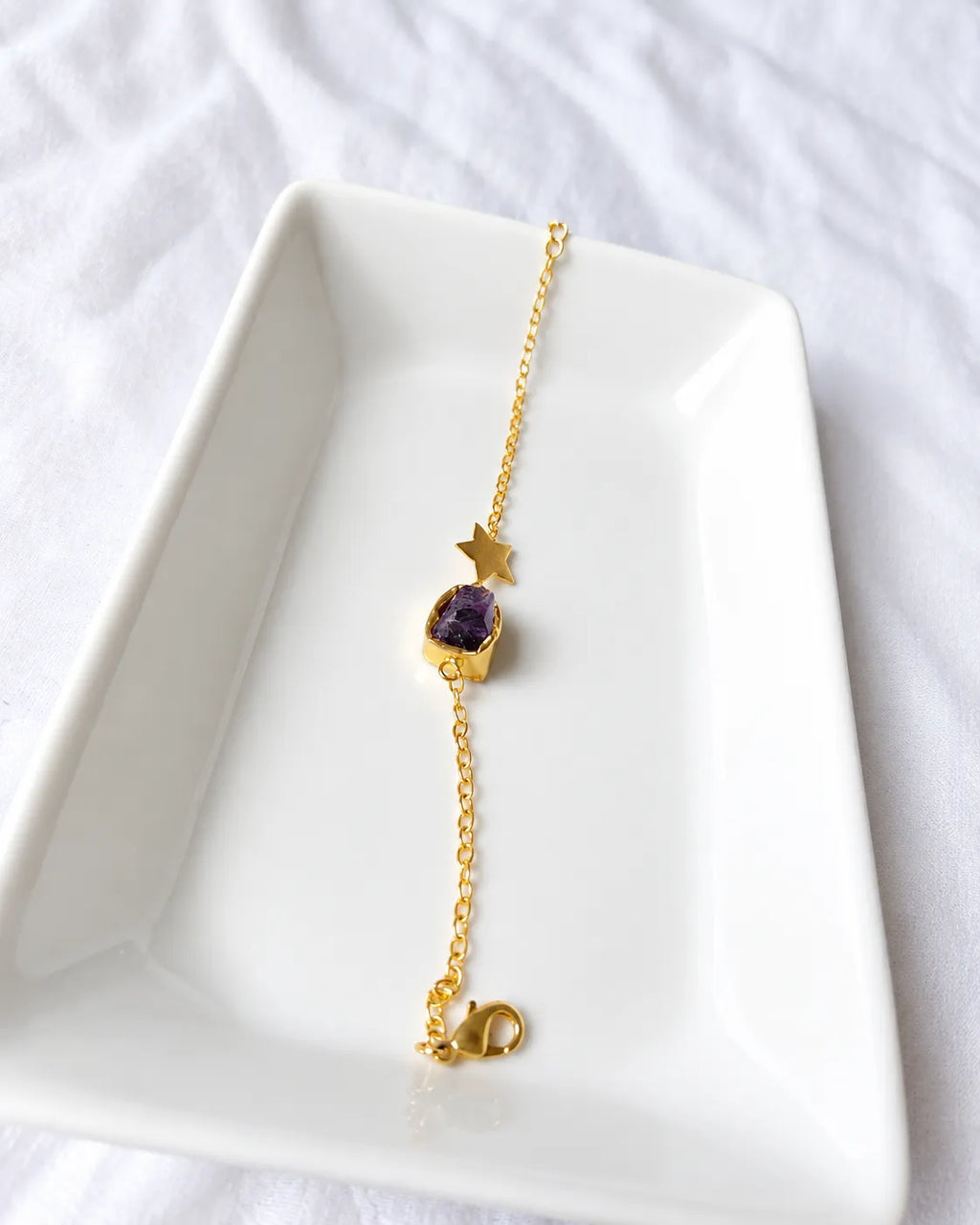 Amethyst star bracelet angled view on white jewelry tray