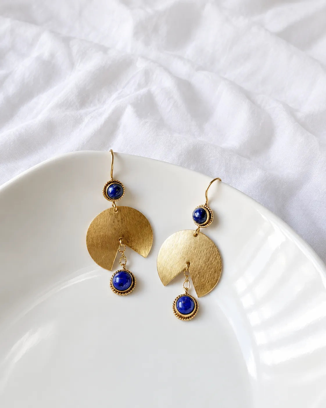 Lapis Lazuli gold fan drop earrings on white dish