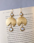 Moonstone gold earrings styled on book