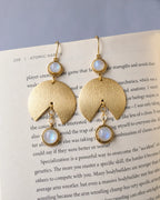 Moonstone gold earrings styled on book