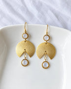 Moonstone gold fan earrings on white dish