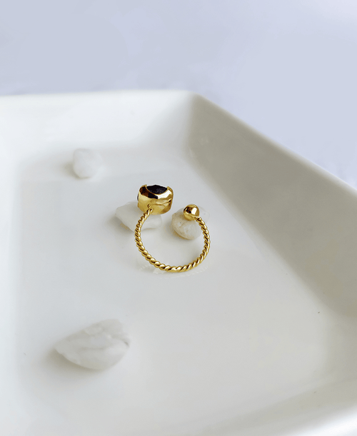 Natural Amethyst adjustable gold ring with purple raw gemstone on soft white background.