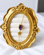 Amethyst star bracelet close-up on ornate gold frame