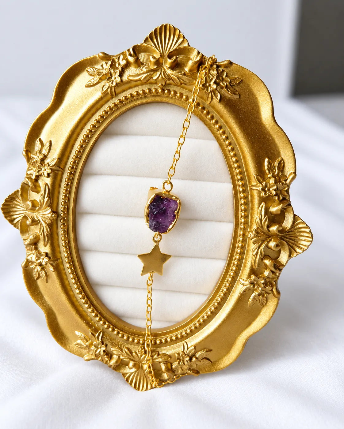 Amethyst star bracelet close-up on ornate gold frame