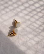 Moon Pebble Moonstone Stud Earrings with raw milky moonstone gemstones and 18K gold-plated bezel setting.