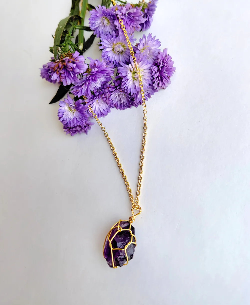 Gilded Violet Crystal Necklace with natural raw amethyst crystal and 18K gold-plated wire-wrapped pendant.