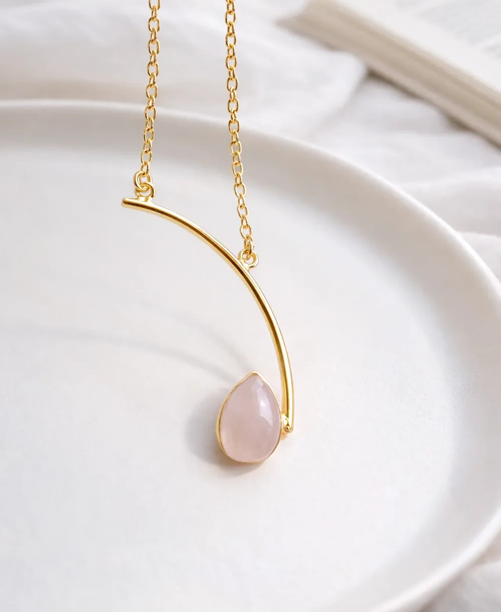 Love Curve Rose Quartz Necklace with natural pink teardrop gemstone and 18K gold-plated curved pendant.