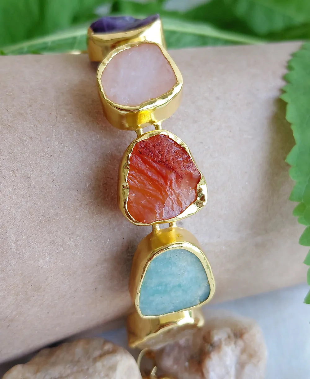 Vibrant Aura natural stone bracelet displayed on a beige stand