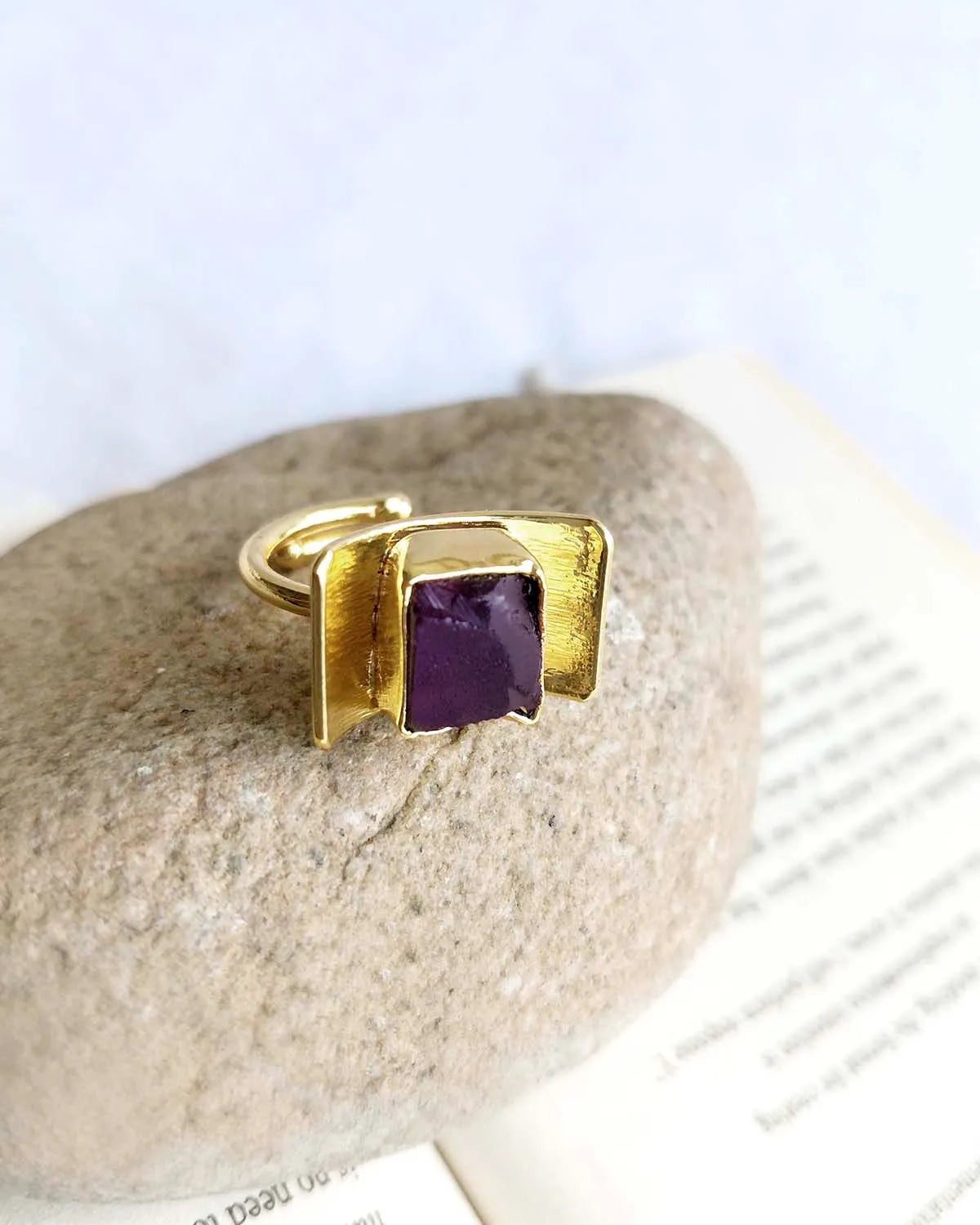 Amethyst gold plated gemstone ring on natural stone