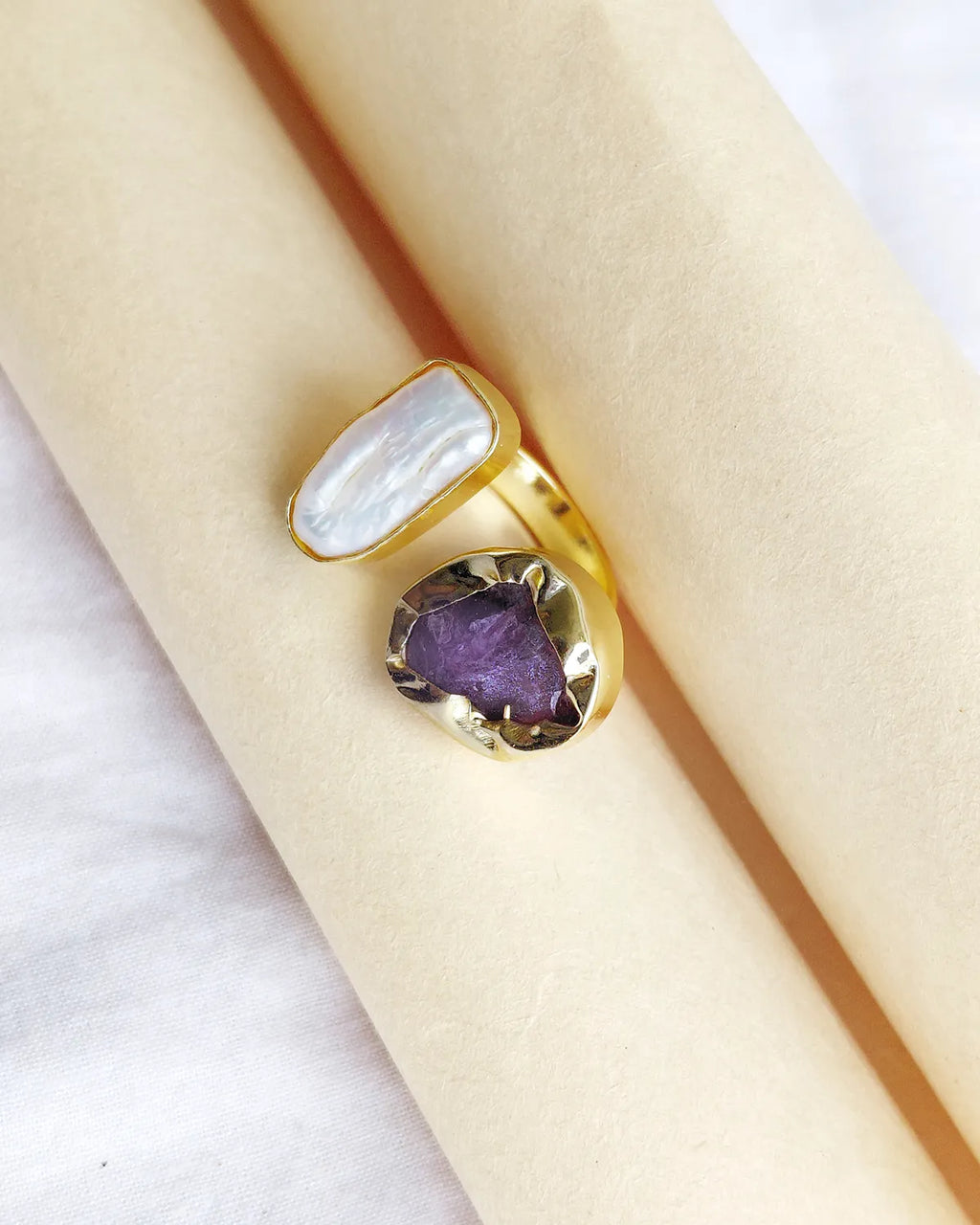 Natural amethyst and pearl gold plated ring close-up