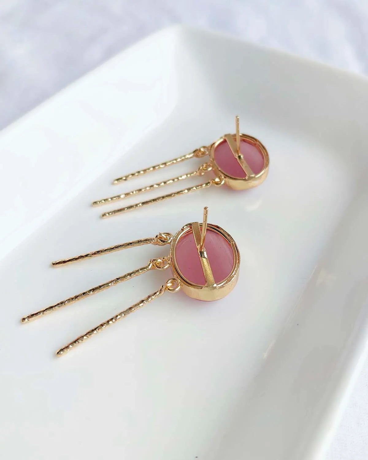 Back view of blush pink gemstone gold-plated drop earrings