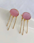 Close-up of blush pink gemstone gold-plated drop earrings