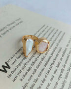 Gold plated dual stone ring photographed on an open book