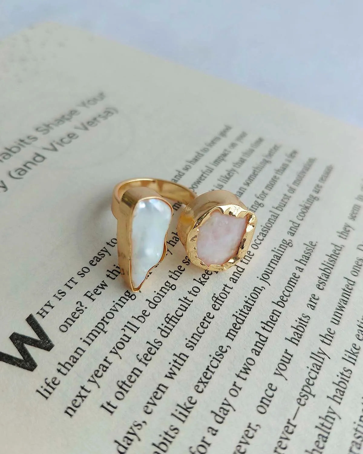 Gold plated dual stone ring photographed on an open book